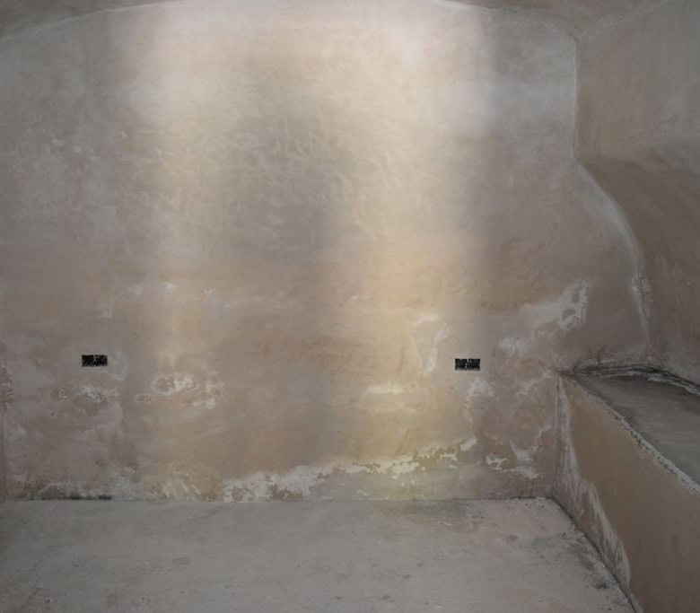Interior view of a rustic cave house in Caniles, Granada, showcasing natural stone walls and unique.