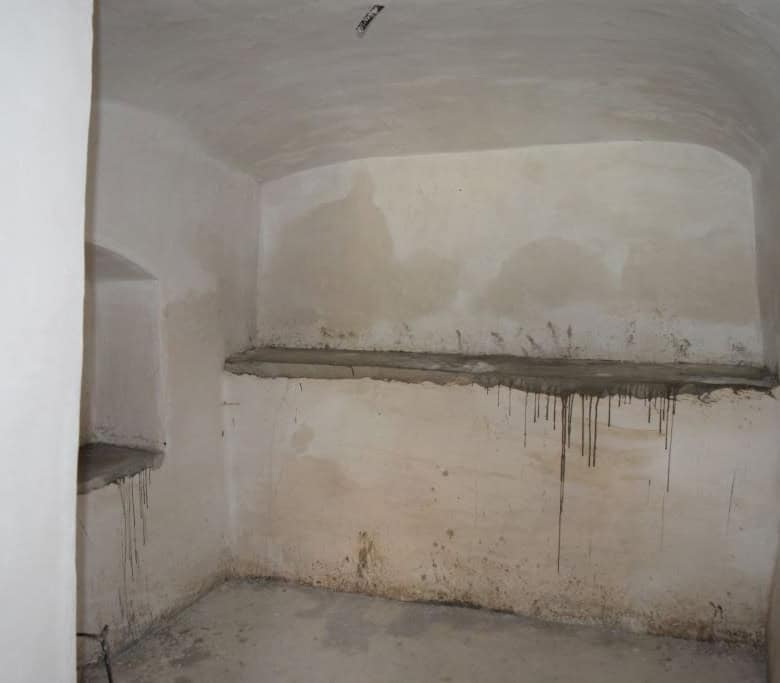 Cave house interior with rough walls and simple shelving in Caniles, Granada. Unique property for sa.