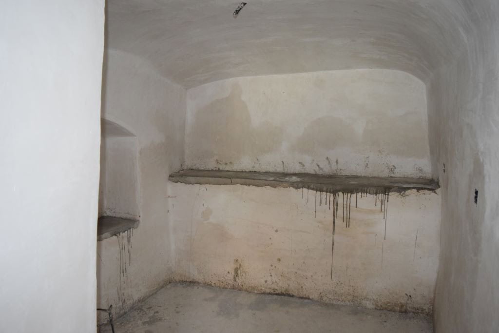 Cave house interior with rough walls and simple shelving in Caniles, Granada. Unique property for sa.
