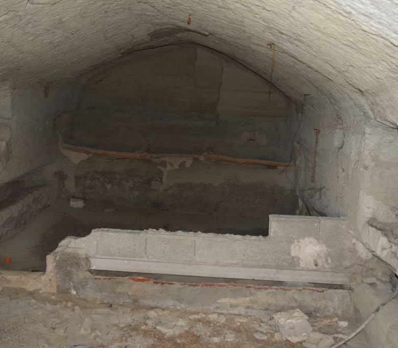 Cave house interior with stone walls and arched ceiling in Benamaurel, Granada, showcasing tradition.