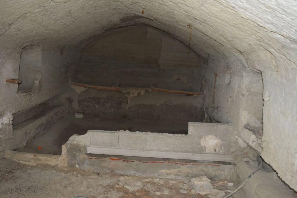 Cave house interior with stone walls and arched ceiling in Benamaurel, Granada, showcasing tradition.