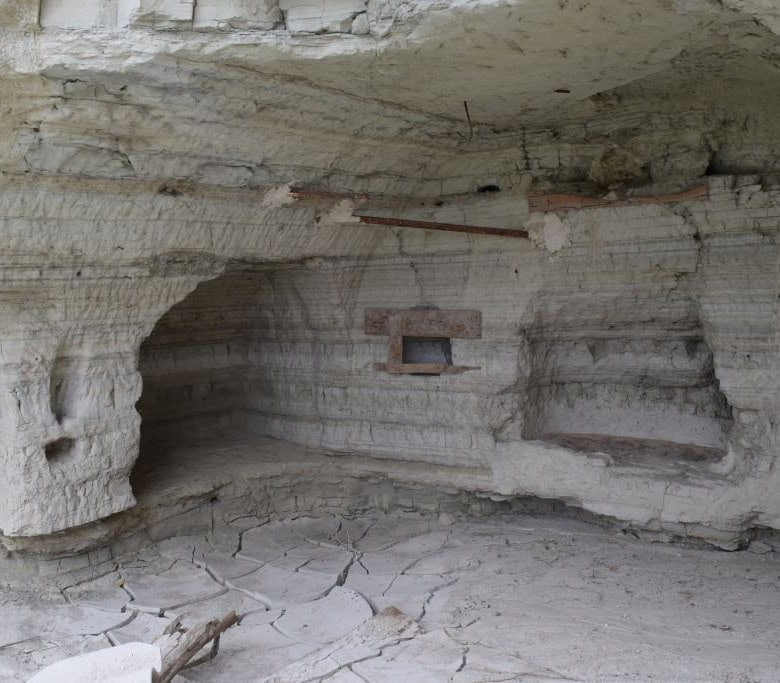 Cave house interior in Benamaurel, Granada, showcasing natural rock walls and unique architecture.