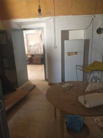 Interior view of a rustic village home in Somontin, Almeria, featuring simple furnishings and tradit.
