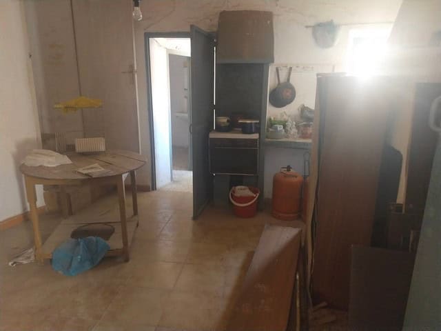 Charming village home interior in Somontin, Almeria, featuring rustic kitchen and cozy living space.