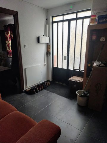 Charming village property entrance with door and shoe rack in Urracal, Almeria. Cozy and inviting sp.