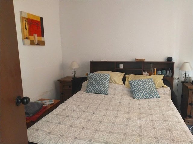 Cozy bedroom in Urracal village property, Almeria, with simple decor and natural light.