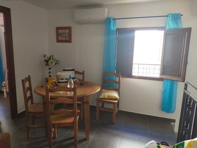 Charming village home in Urracal, Almeria with cozy dining area and bright window.