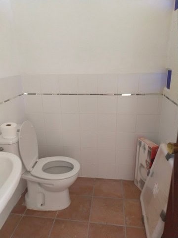 Cozy village property in Urracal, Almeria, featuring a simple bathroom with white tiles and basic fi.