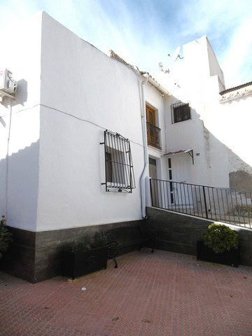 Charming village property in Urracal, Almeria with white exterior walls and a small outdoor patio ar.