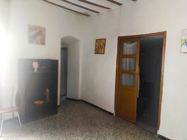 Charming interior of a town house in Velez Blanco, Almeria, featuring a cozy room with wooden door a.