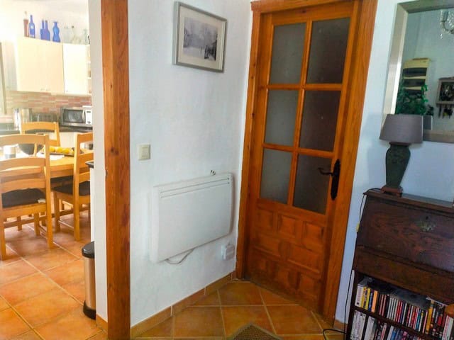 Cozy interior of a rural home in Seron, Almeria, featuring wooden doors and a warm, inviting atmosph.