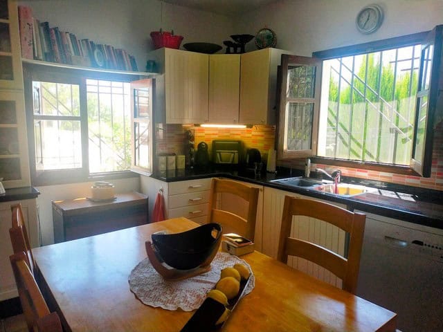 Bright kitchen with open windows in Seron, Almeria, showcasing a cozy rural home.