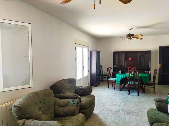 Spacious living area with comfortable sofas and a dining table in a villa located in Hijate, Almeria.