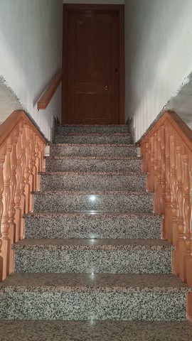 Indoor staircase with wooden handrails in a rural property in Seron, Almeria.