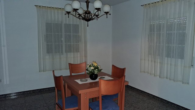 Bright dining room with wooden table and chairs in a rural property in Seron, Almeria.