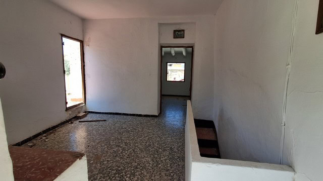 Town house interior in Tijola, Almeria, with white walls and tiled floors.