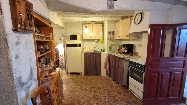 Charming village home kitchen in Somontin, Almeria with rustic features and traditional decor.
