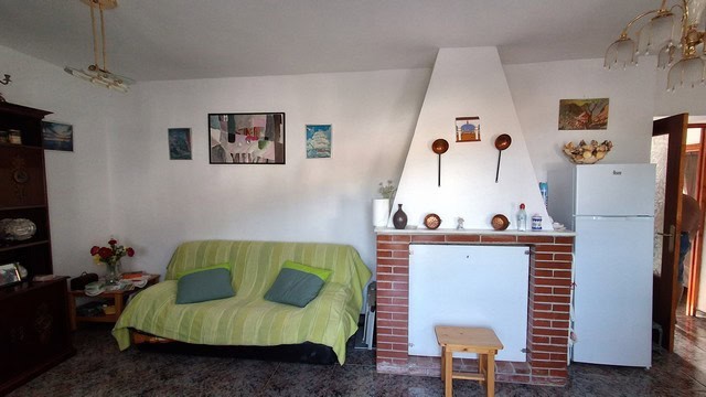 Charming village home interior in Somontin, Almeria with cozy living room, fireplace, and traditiona.