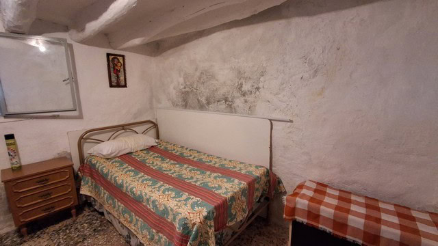 Cozy village home interior in Somontin, Almeria with rustic walls and simple furnishings.