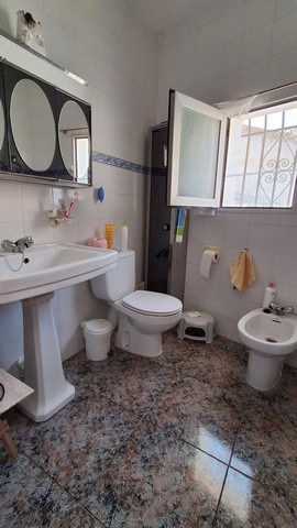 Charming village home bathroom in Somontin, Almeria with traditional fixtures and natural light.