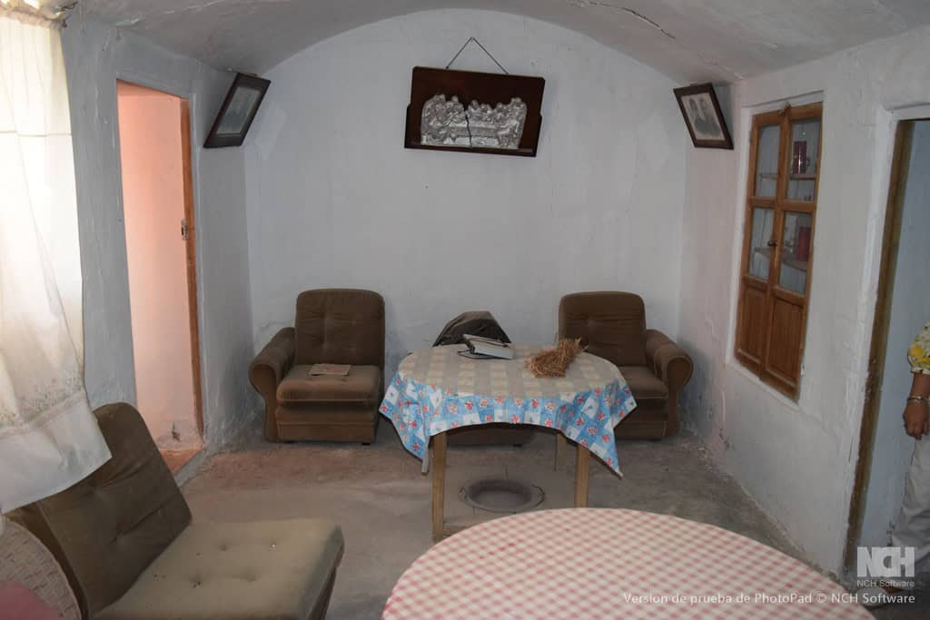 Cozy cave house living room with rustic furniture and traditional decor in Cullar, Granada.