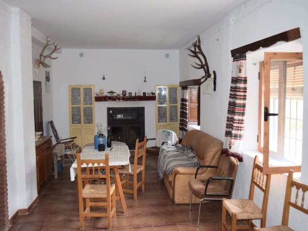 Cozy farm property interior with rustic decor in Baza, Granada, featuring wooden furniture and tradi.