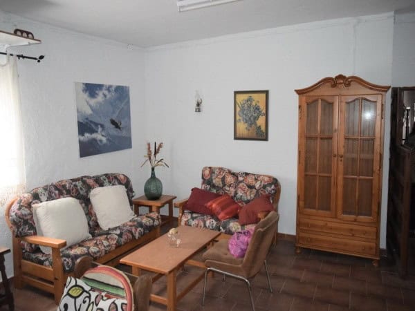 Charming farm property in Baza, Granada, featuring cozy living room with traditional furniture and r.
