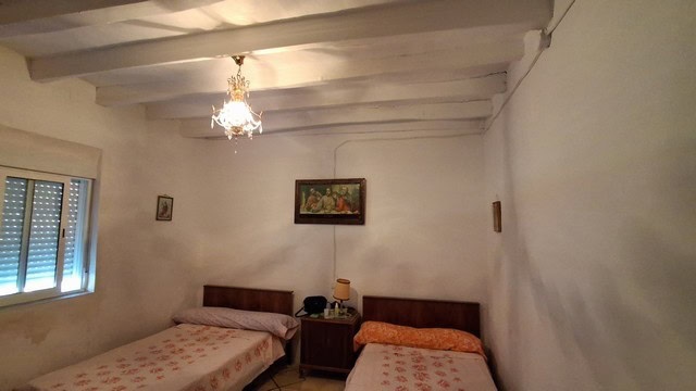 Charming rural property in Tijola, Almeria, featuring a cozy bedroom with traditional decor and rust.