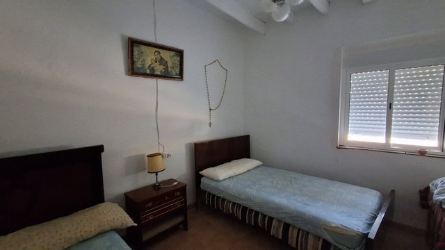 Cozy bedroom in rural Tijola property with simple furnishings and natural light.