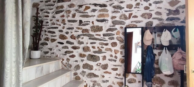 Town house entrance with stone wall and coat rack in Seron, Almeria.