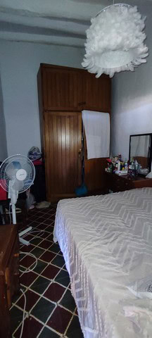 Charming town house interior in Seron, Almeria, featuring wooden furniture, a bed, and basic ameniti.