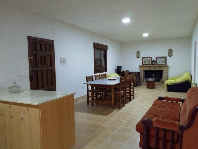 Interior view of a rural property in Purchena, Almeria, featuring a dining area and cozy living spac.