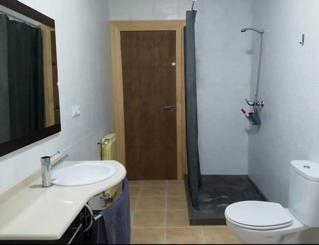 Cozy bathroom in a rural property in Purchena, Almeria, featuring a shower, toilet, and sink. Ideal.