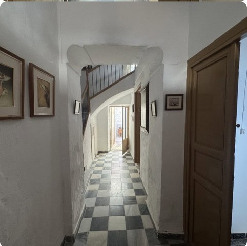 Town House interior hallway in Purchena, Almeria, with checkered flooring and framed artwork.