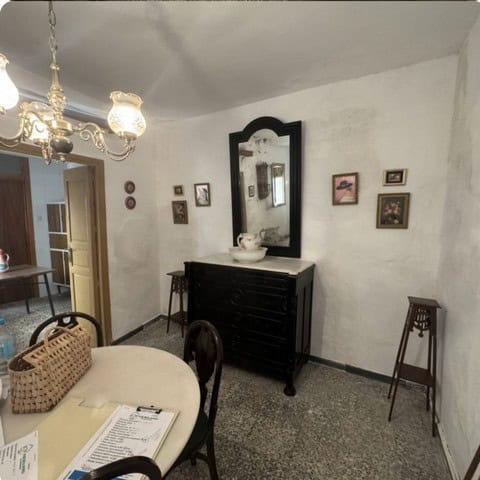 Cozy interior of a town house in Purchena, Almeria, featuring vintage furniture and decorative wall.
