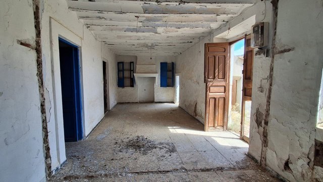 Interior view of a rustic rural property in Albox, Almeria, showing an unfinished room with exposed.