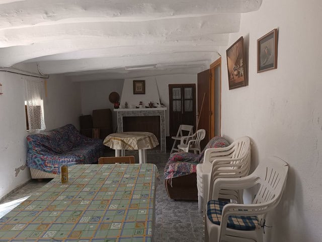 Traditional rural property interior with simple furniture and rustic charm in Caniles, Granada.
