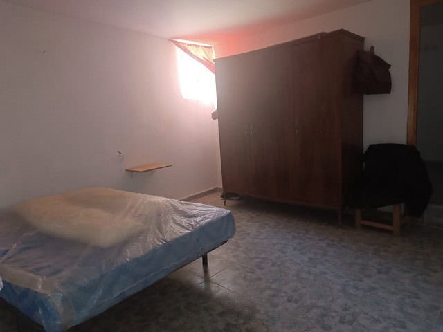 Rural property interior in Caniles, Granada with simple furnishings and natural light.