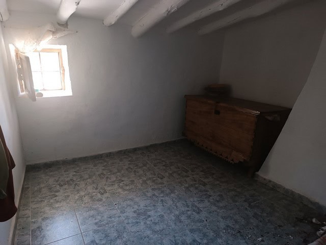 Charming rural property interior in Caniles, Granada with rustic wooden furniture and natural light.