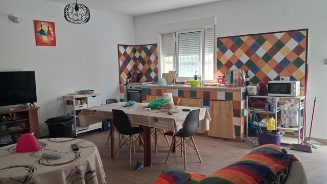 Bright living space featuring a dining area, colorful wall panels, and essential appliances.