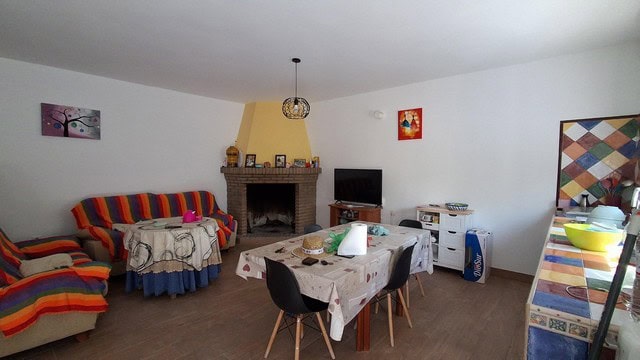 Cozy living room in a villa located in Armuna, Almeria, featuring colorful furniture and a fireplace.