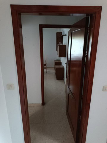 Apartment door in Seron, Almeria with wooden frame and interior view.