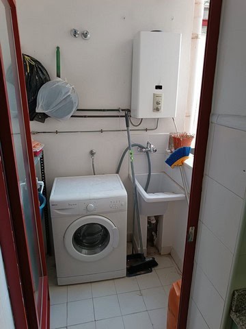 Compact laundry space with washing machine and utility sink in Seron, Almeria.