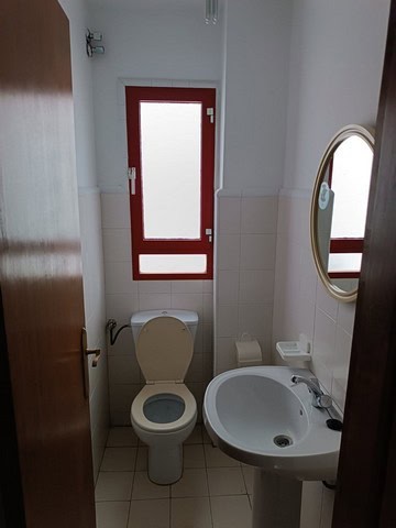 Cozy bathroom in Seron, Almeria with toilet, sink, and window.