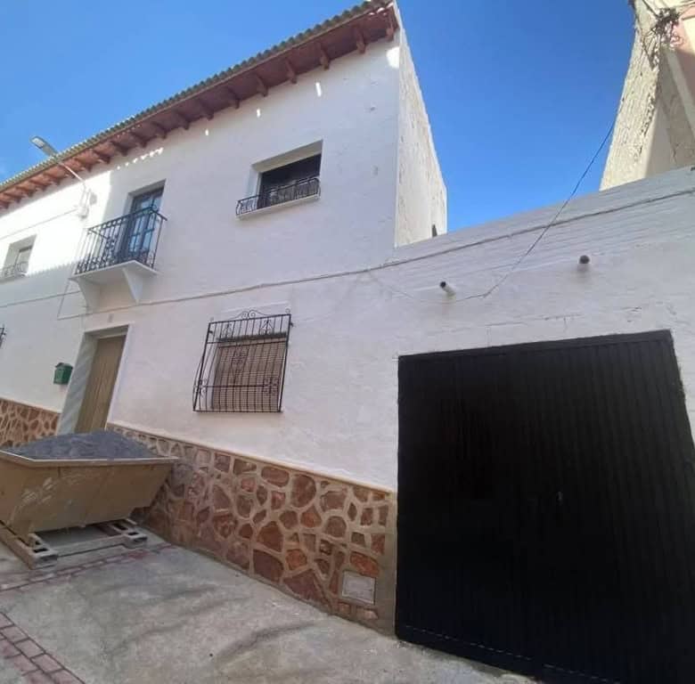 Town house with white exterior walls and a garage in Purchena, Almeria, Spain.