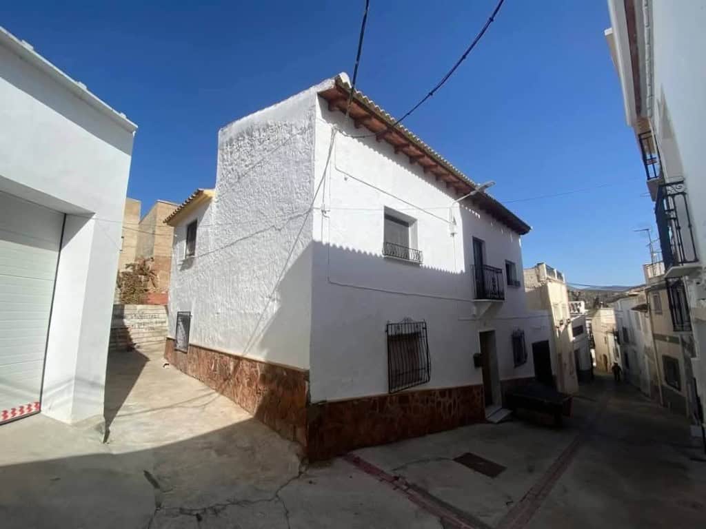 Charming town house in Purchena, Almeria, with traditional white exterior and rustic features.