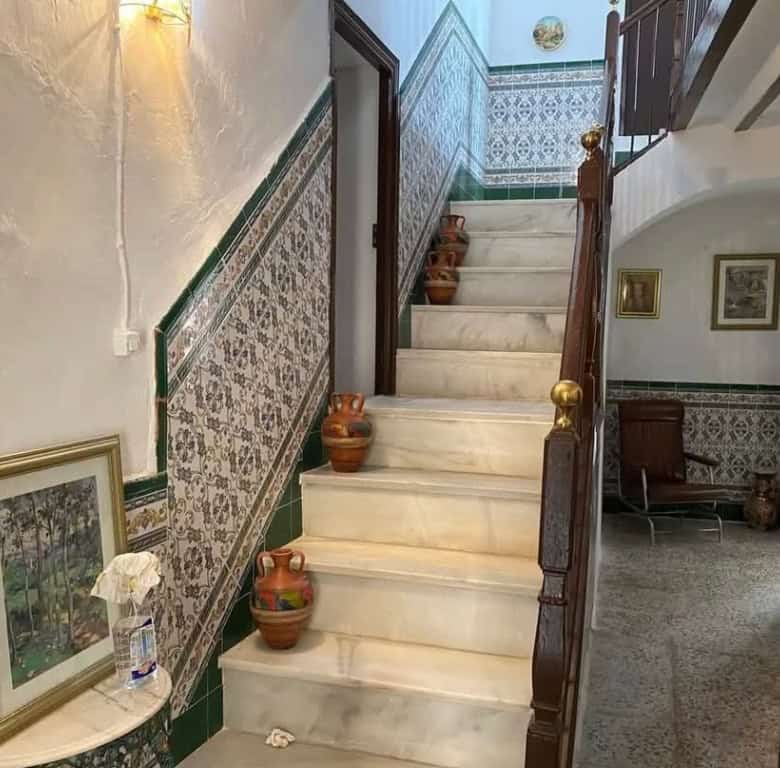 Town House Staircase in Purchena, Almeria with decorative tiles and classic wooden handrail.