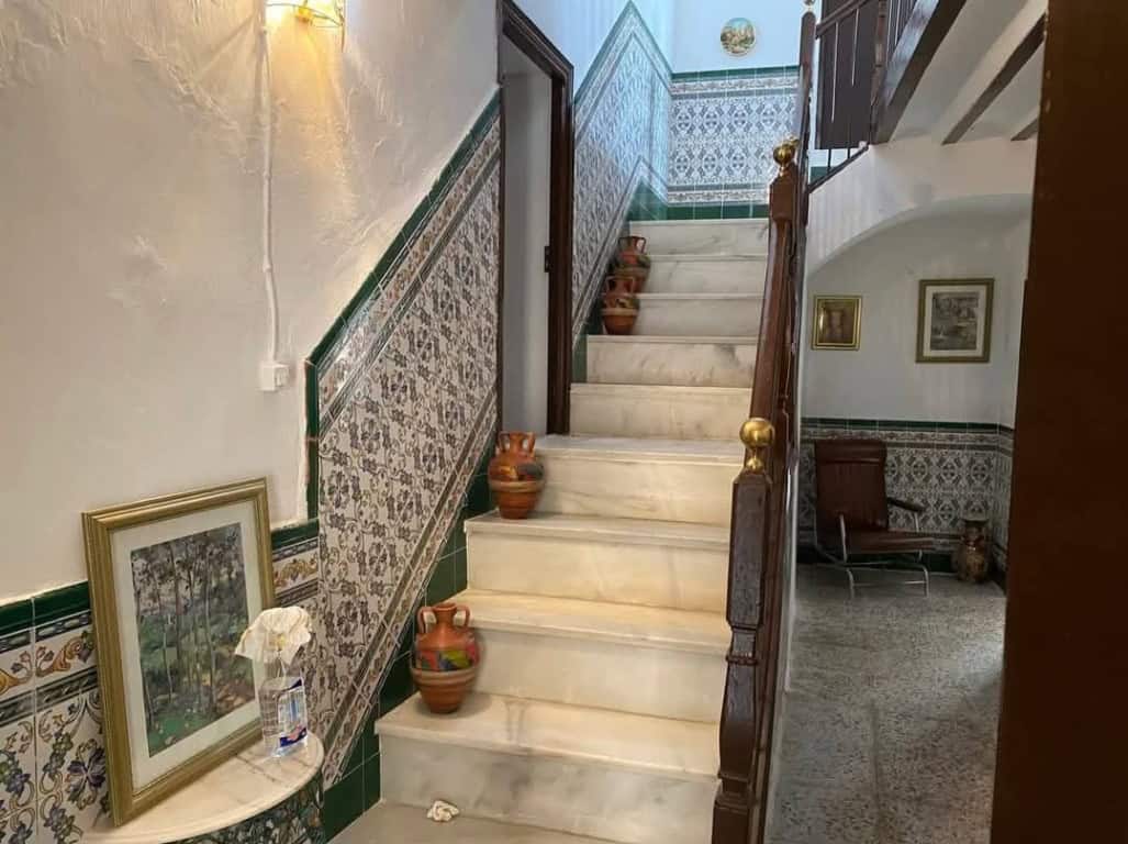 Town House Staircase in Purchena, Almeria with decorative tiles and classic wooden handrail.