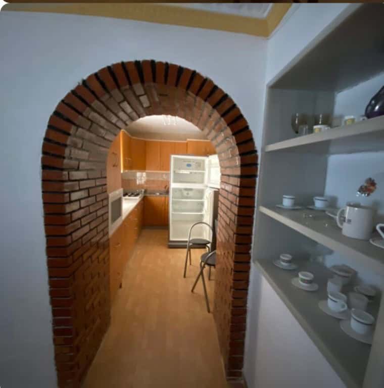 Charming kitchen with brick archway in a traditional town house in Purchena, Almeria.