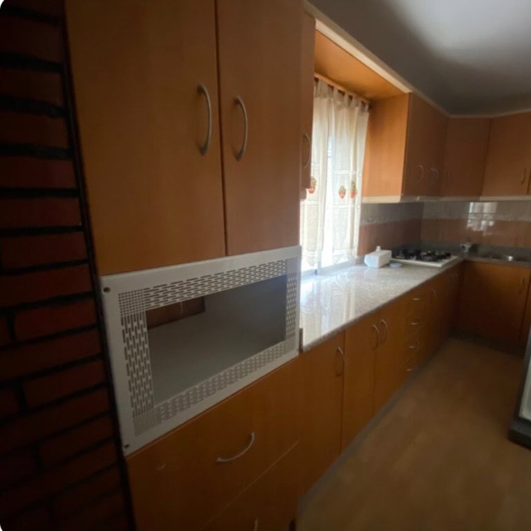 Cozy kitchen in a town house located in Purchena, Almeria, featuring wooden cabinets and a bright wi.